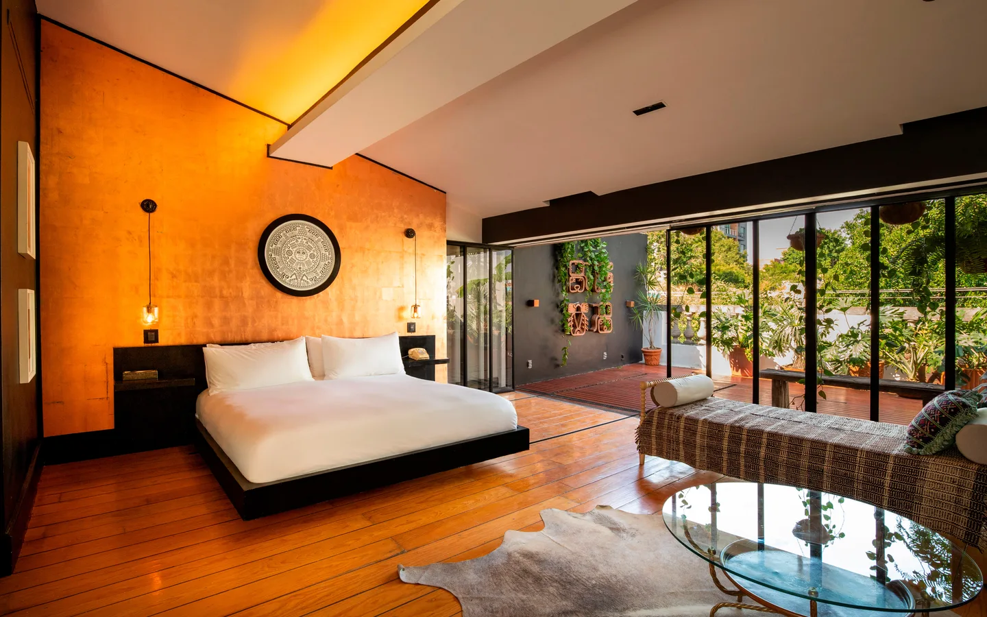 Bed and daybed looking out to the planted terrace — Polaris Suite, La Valise Mexico City