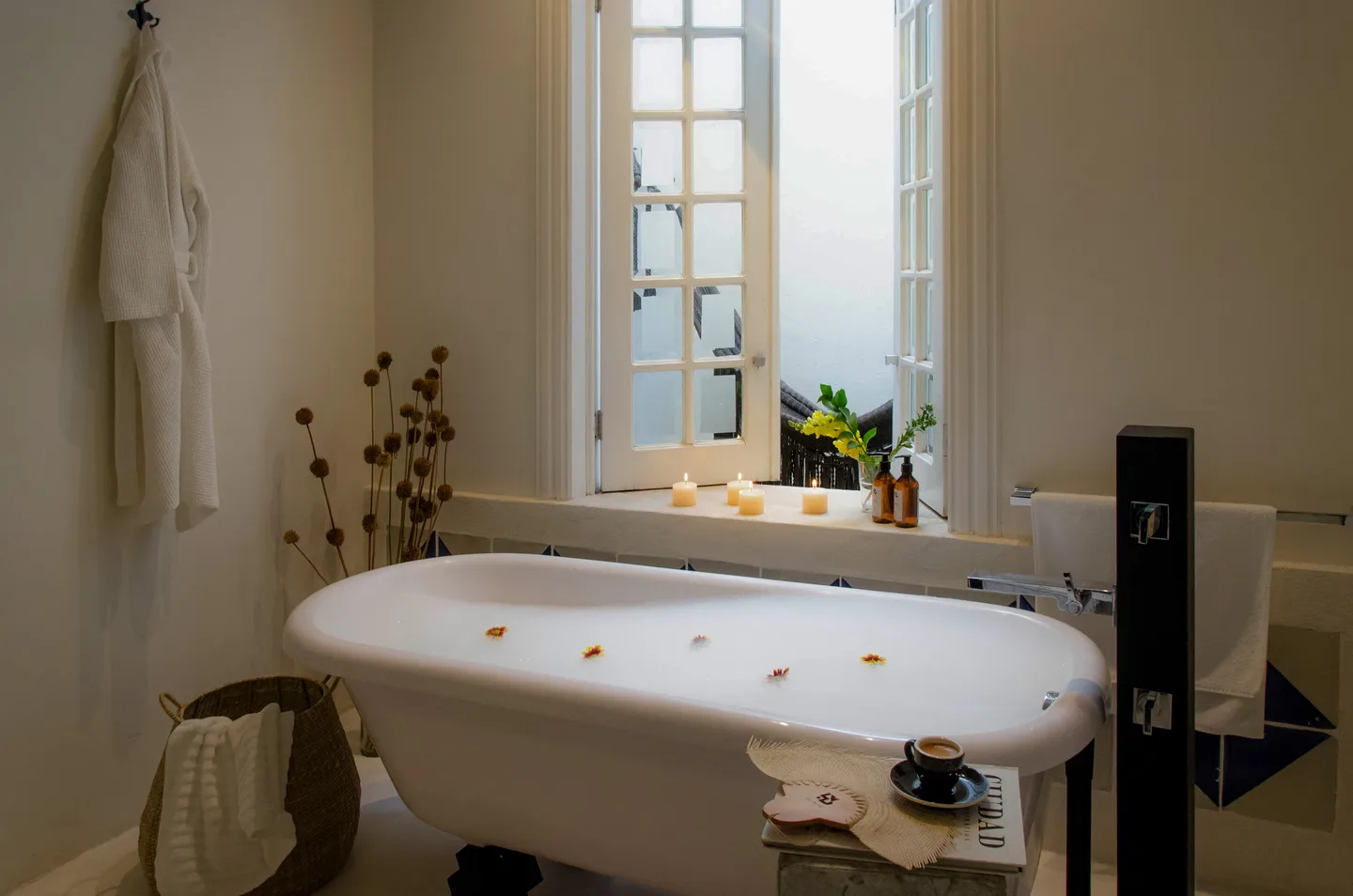 Freestanding bathtub by the window with a robe hanging beside it — Gravity Suite, La Valise Mexico City