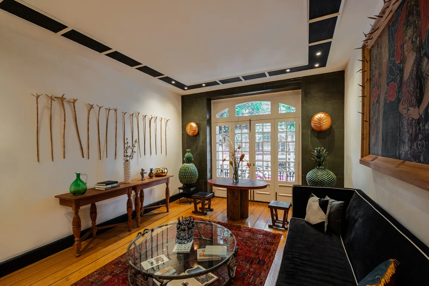 Seating area with wall sculpture and tapestry — Gravity Suite, La Valise Mexico City