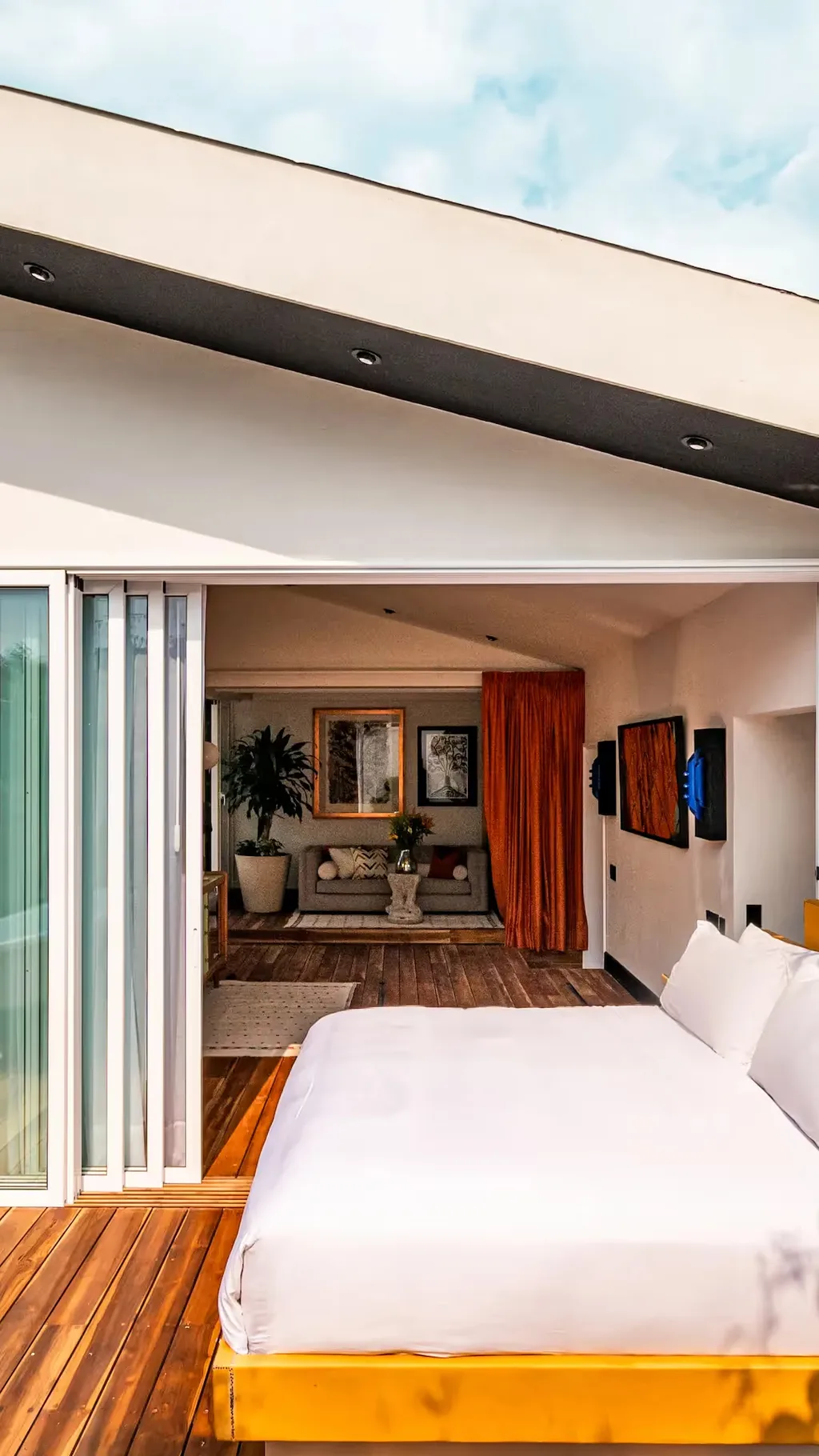 Suite with a rolling bed on a wooden terrace and forest views at La Valise Mexico City Hotel.