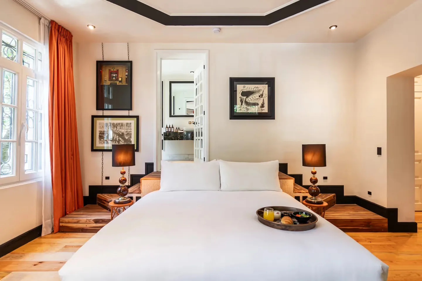 Bright and elegant hotel room at La Valise Mexico City Hotel, featuring a welcome tray and refined design.